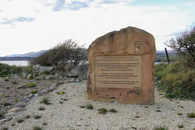 a sign in the middle of a rocky area