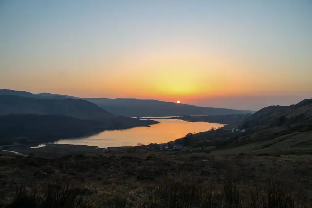 a body of water surrounded by hills