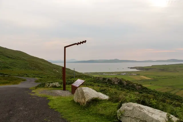 a road with grass and rocks on the side