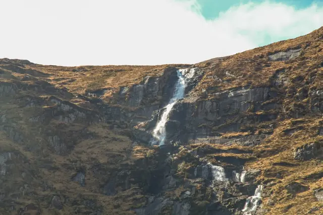 a waterfall on a rocky mountain
