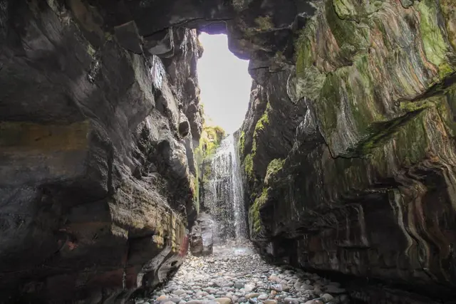 a stone walkway between large rocks