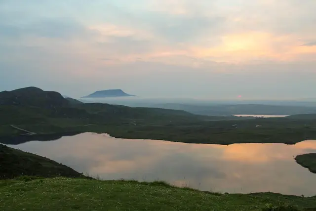 a body of water surrounded by hills